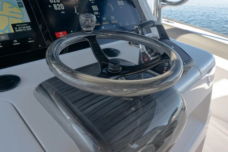 Yacht Photos Pics Steering wheel and controls of 2026 Mag Bay 43 CC boat, featuring advanced navigation displays.