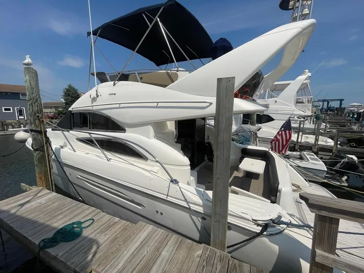  Yacht Photos Pics 2001 Viking Princess 45 Flybridge Sport Cruiser docked at marina.