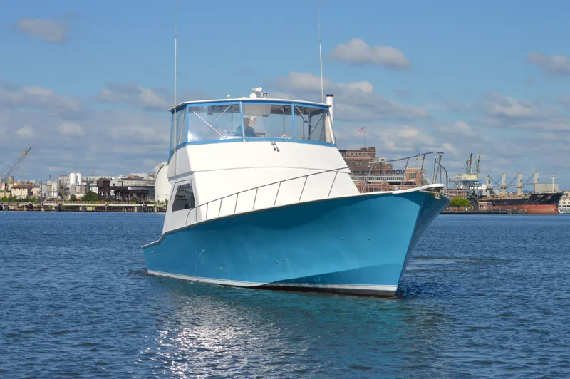 Custom Yacht Photos Pics 2004 Chesapeake 58 boat on calm water with cityscape background.