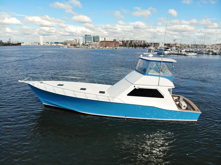 Custom Yacht Photos Pics 2004 Chesapeake 58 boat on calm water with city skyline.