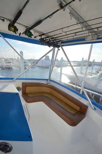 Custom Yacht Photos Pics Interior of a 2004 Chesapeake 58 boat with seating area and fishing rods.