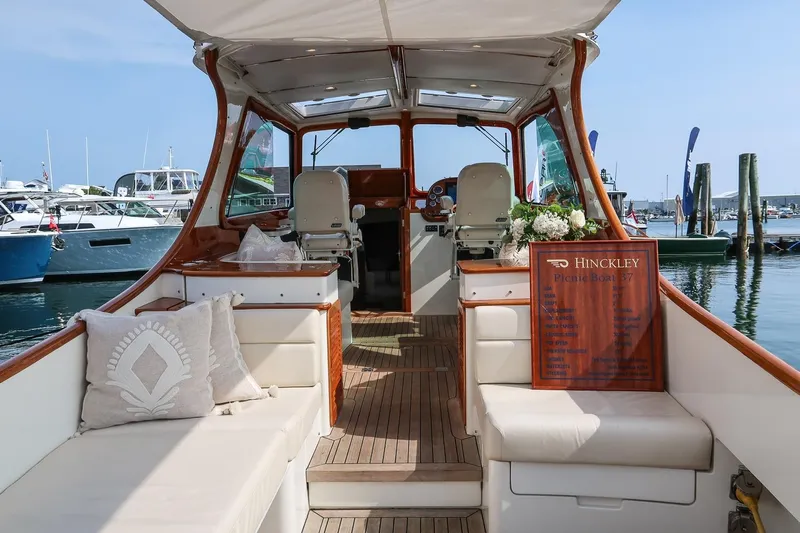 Bristol Yacht Photos Pics 2015 Hinckley Picnic Boat 37 MKIII interior with elegant seating and wooden accents at a marina.