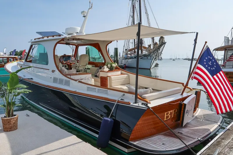 Bristol Yacht Photos Pics 2015 Hinckley Picnic Boat 37 MKIII docked with American flag and canopy.