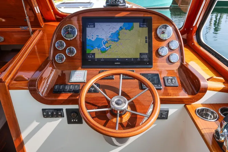 Bristol Yacht Photos Pics Helm of 2015 Hinckley Picnic Boat 37 MKIII with navigation display and wooden steering wheel.