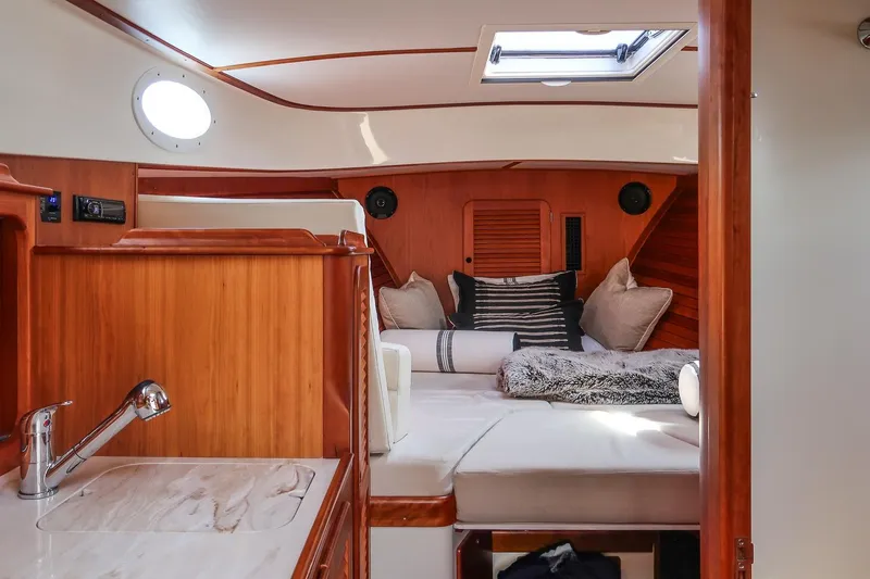 Bristol Yacht Photos Pics Luxurious interior of 2015 Hinckley Picnic Boat 37 MKIII with cozy seating and elegant wood finish.