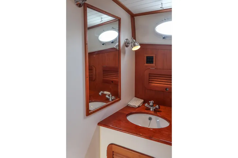 Bristol Yacht Photos Pics 2015 Hinckley Picnic Boat 37 MKIII bathroom with wooden vanity and mirror.