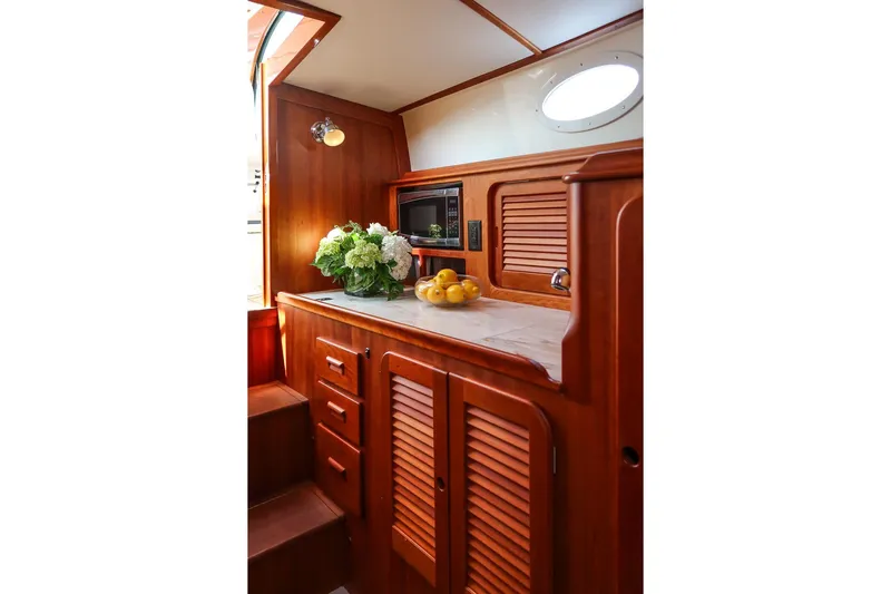 Bristol Yacht Photos Pics Interior of 2015 Hinckley Picnic Boat 37 MKIII with wooden cabinetry and countertop decor.