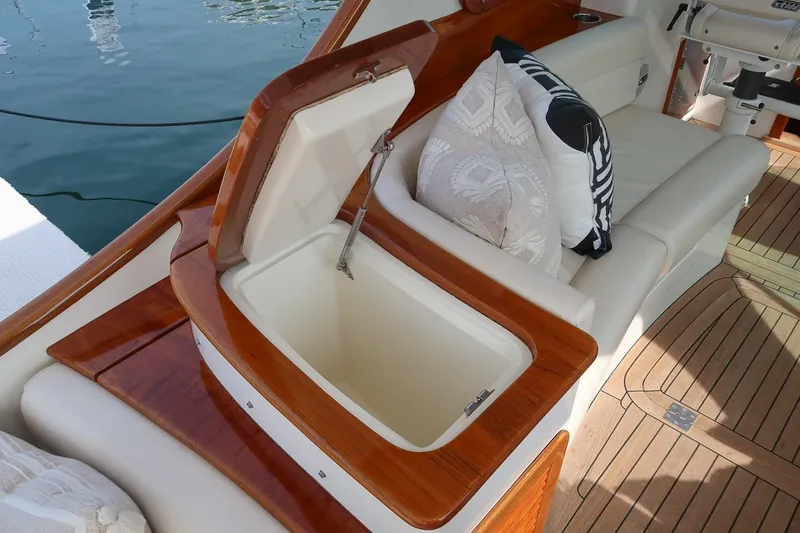 Bristol Yacht Photos Pics 2015 Hinckley Picnic Boat 37 MKIII interior with open storage compartment and cushioned seating.