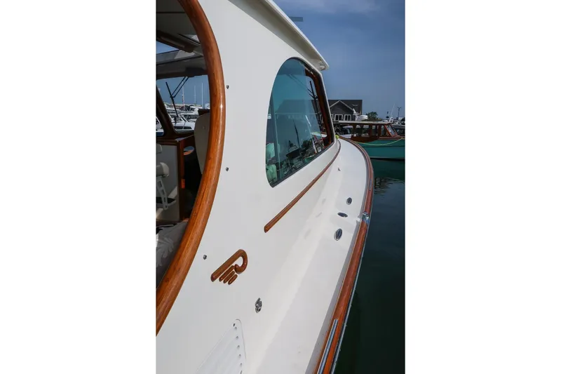 Bristol Yacht Photos Pics 2015 Hinckley Picnic Boat 37 MKIII with elegant wood trim, docked in a marina.