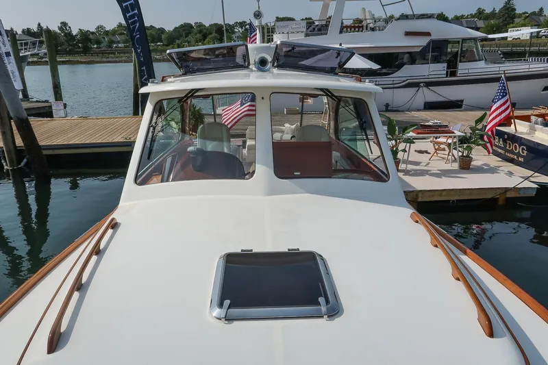 Bristol Yacht Photos Pics 2015 Hinckley Picnic Boat 37 MKIII docked, showcasing sleek design and American flag.