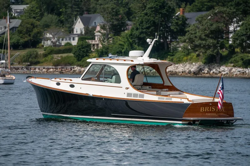 Bristol Yacht Photos Pics 2015 Hinckley Picnic Boat 37 MKIII cruising on a scenic waterfront.