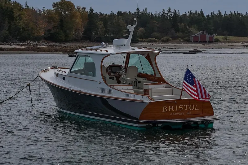 Bristol Yacht Photos Pics 2015 Hinckley Picnic Boat 37 MKIII on water, American flag, scenic background.