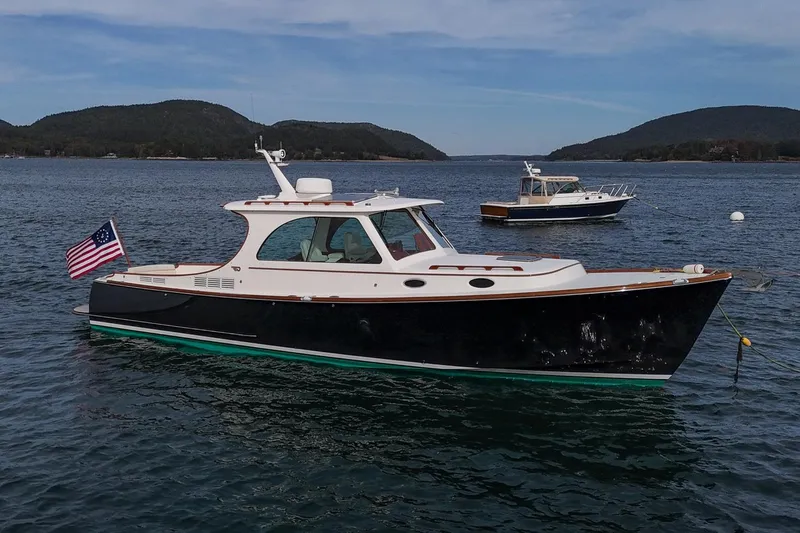 Bristol Yacht Photos Pics 2015 Hinckley Picnic Boat 37 MKIII on calm water with scenic mountain backdrop.