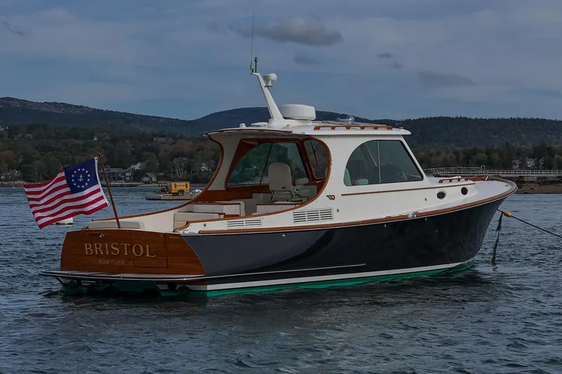 Bristol Yacht Photos Pics 2015 Hinckley Picnic Boat 37 MKIII on water, displaying American flag, scenic background.