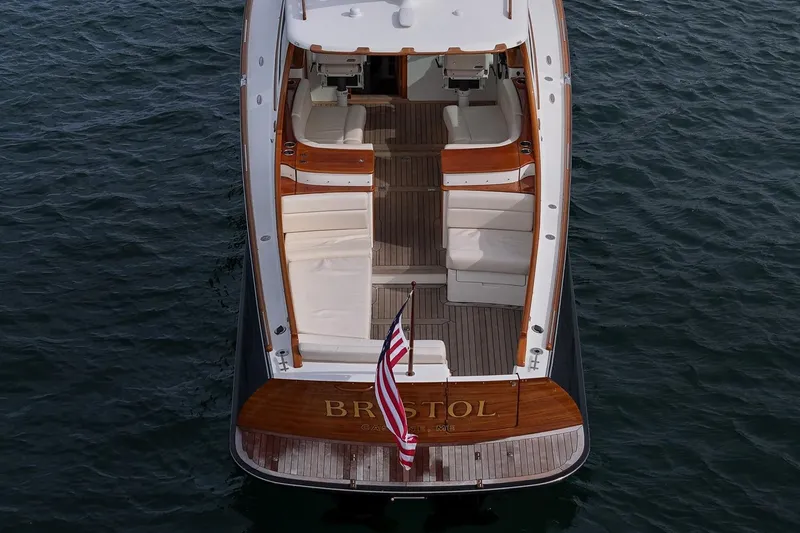 Bristol Yacht Photos Pics 2015 Hinckley Picnic Boat 37 MKIII on water, elegant design, spacious seating, American flag displayed.