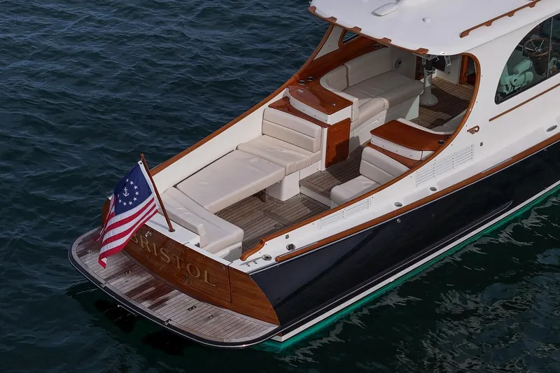 Bristol Yacht Photos Pics 2015 Hinckley Picnic Boat 37 MKIII on water, elegant design with American flag.