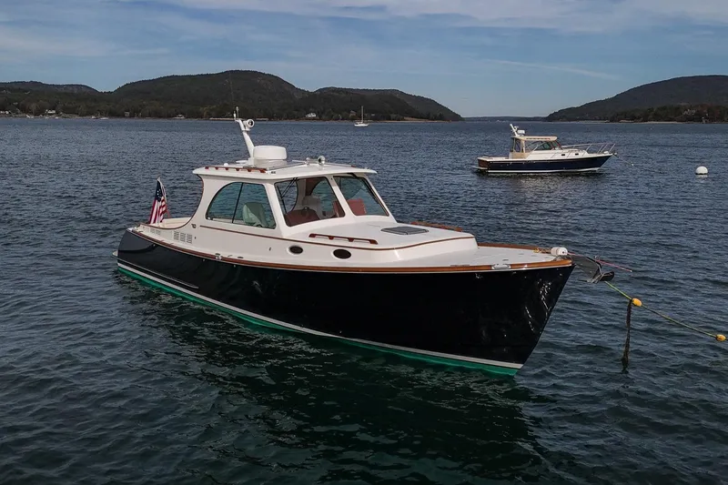Bristol Yacht Photos Pics 2015 Hinckley Picnic Boat 37 MKIII on serene water with scenic hills in background.