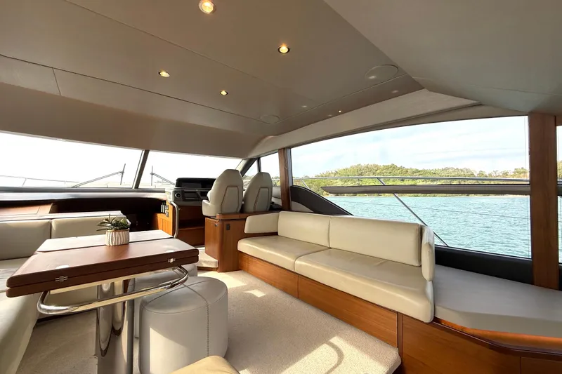 Lariel Yacht Photos Pics Luxurious interior of 2020 Princess F55 yacht with elegant seating and scenic water view.