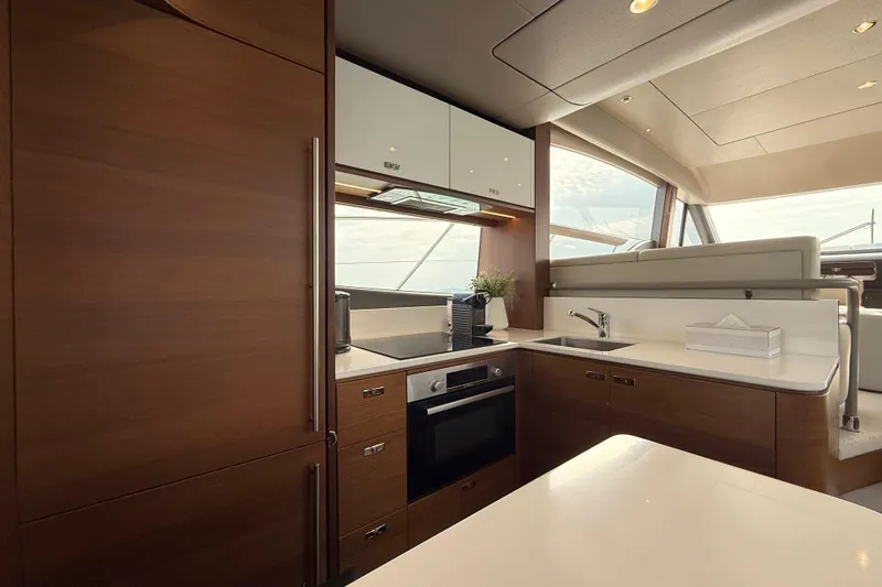 Lariel Yacht Photos Pics Luxurious kitchen interior of 2020 Princess F55 yacht with modern appliances and sleek design.