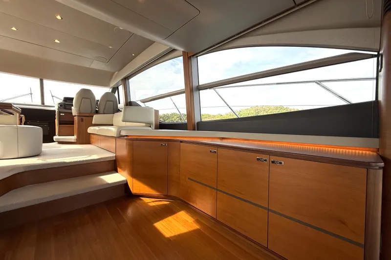 Lariel Yacht Photos Pics Luxurious interior of 2020 Princess F55 yacht with elegant wood finishes and modern seating.