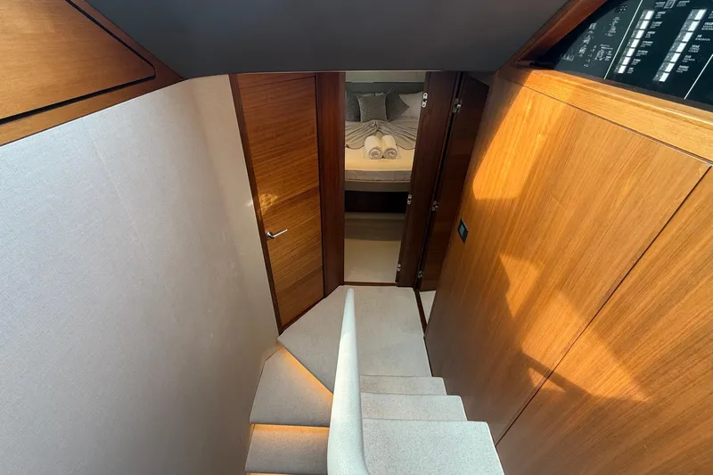 Lariel Yacht Photos Pics Luxurious interior of 2020 Princess F55 yacht with wooden finishes and cozy bedroom.