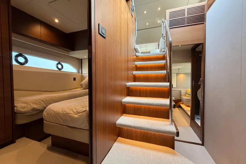 Lariel Yacht Photos Pics Luxurious interior of 2020 Princess F55 yacht with elegant wooden staircase and cozy cabin.