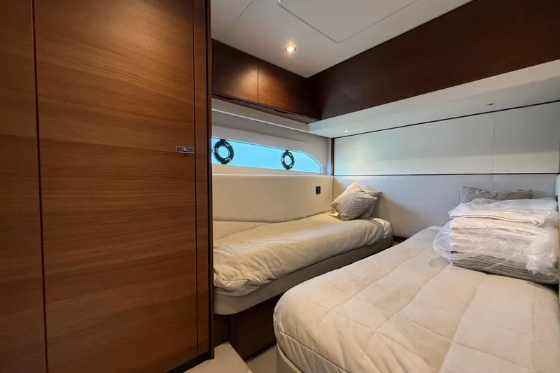 Lariel Yacht Photos Pics Luxurious 2020 Princess F55 yacht cabin with twin beds and elegant wood paneling.