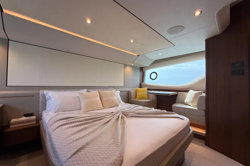 Lariel Yacht Photos Pics Luxurious bedroom interior of 2020 Princess F55 yacht with elegant bedding and seating area.