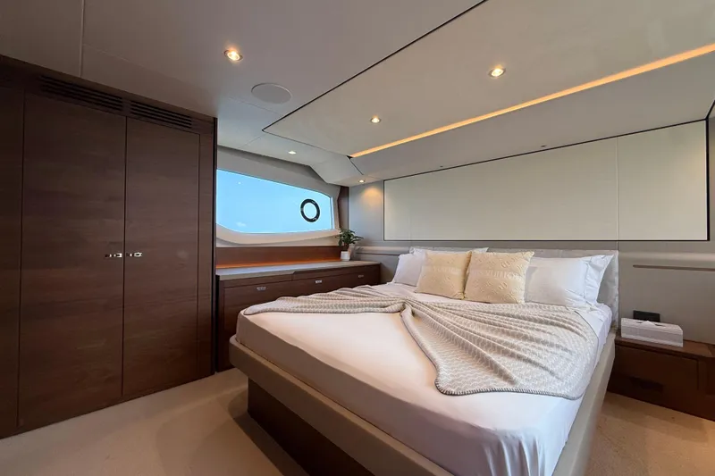Lariel Yacht Photos Pics Luxurious bedroom interior of 2020 Princess F55 yacht with elegant wood finishes.