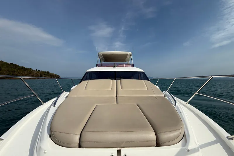 Lariel Yacht Photos Pics 2020 Princess F55 yacht with sunbed, cruising on open sea under clear sky.