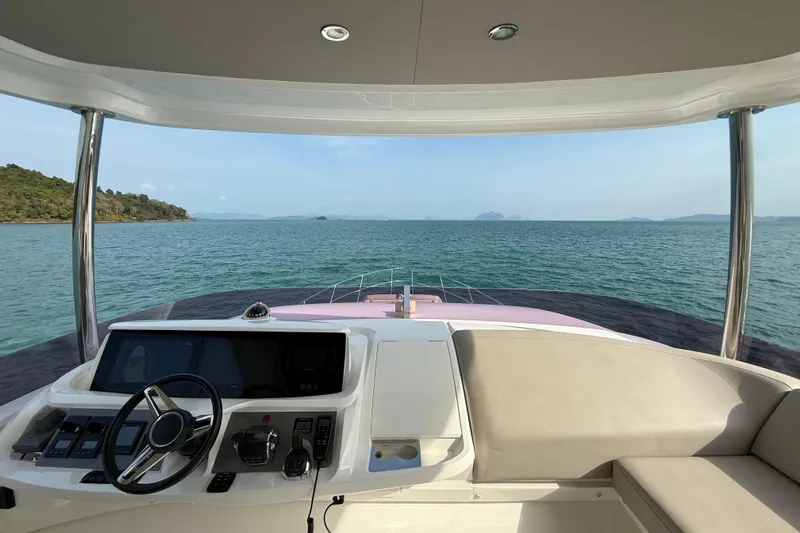 Lariel Yacht Photos Pics Helm of 2020 Princess F55 yacht overlooking serene ocean and distant islands.
