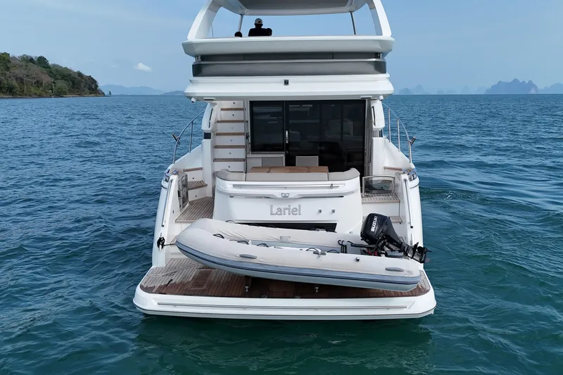 Lariel Yacht Photos Pics Luxury Princess F55 yacht with dinghy on serene ocean waters, 2020 model.
