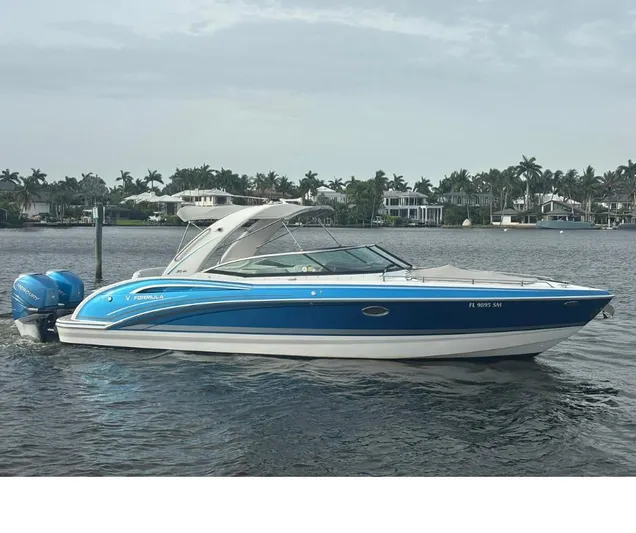  Yacht Photos Pics 2020 Formula 310 Bowrider boat on water, blue and white design, coastal background.