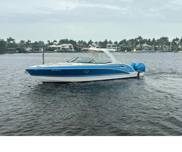  Yacht Photos Pics 2020 Formula 310 Bowrider boat on water, with scenic waterfront background.