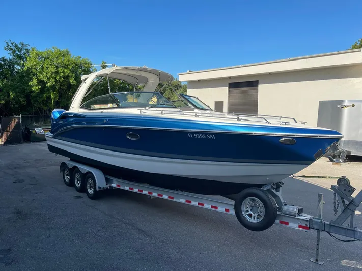  Yacht Photos Pics 2020 Formula 310 Bowrider boat on trailer, blue and white, parked outdoors.