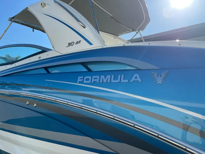  Yacht Photos Pics 2020 Formula 310 Bowrider boat with sleek blue design and branding.