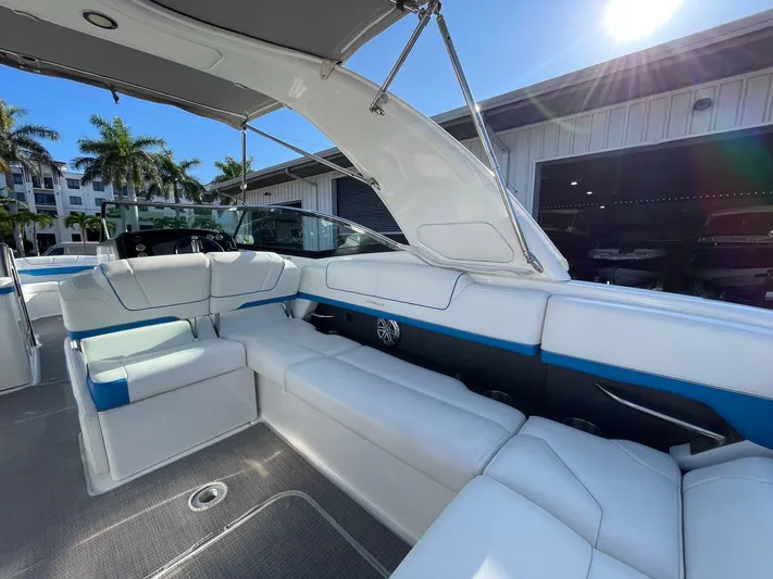 Yacht Photos Pics 2020 Formula 310 Bowrider interior with white seating, blue accents, and sunny outdoor setting.