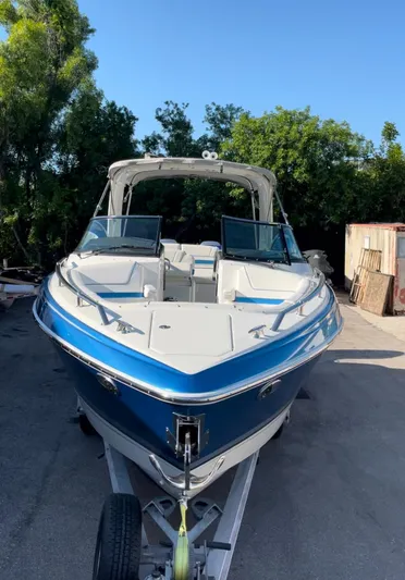  Yacht Photos Pics 2020 Formula 310 Bowrider boat on trailer, blue and white, parked outdoors.