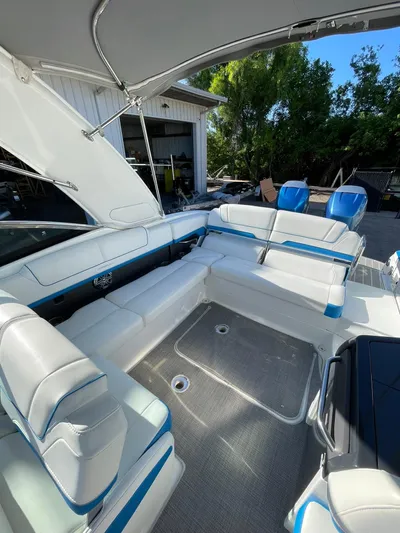  Yacht Photos Pics 2020 Formula 310 Bowrider interior with white and blue seating under canopy.