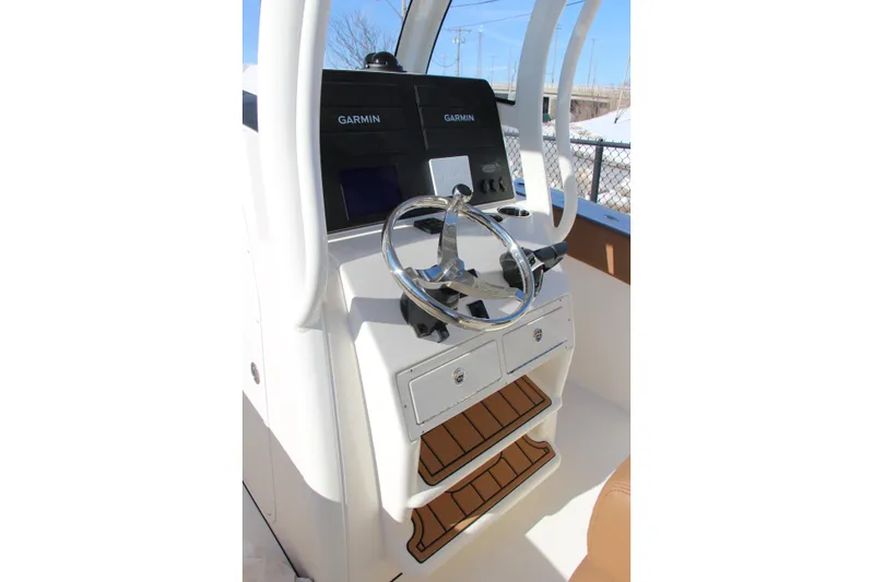  Yacht Photos Pics 2026 Pioneer 270 Pelagic boat helm with Garmin navigation system and stainless steel steering wheel.