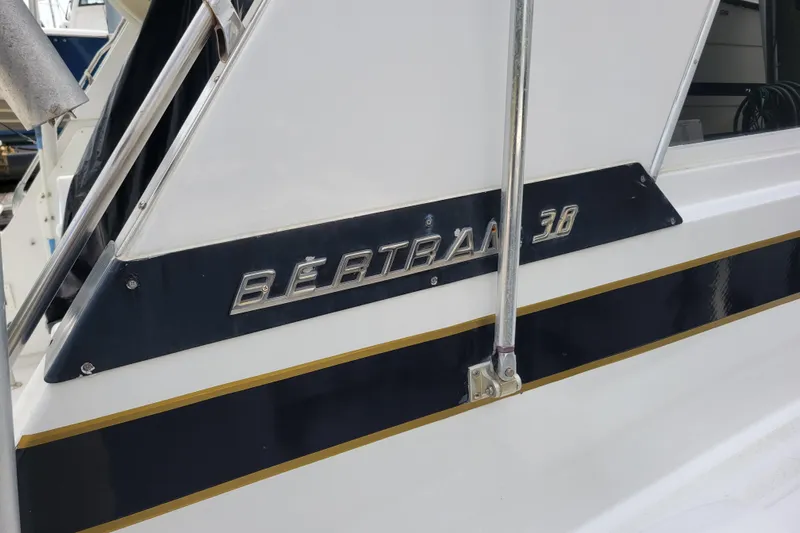 Bout Time Yacht Photos Pics 1979 Bertram 38 Convertible boat with chrome lettering and sleek design.