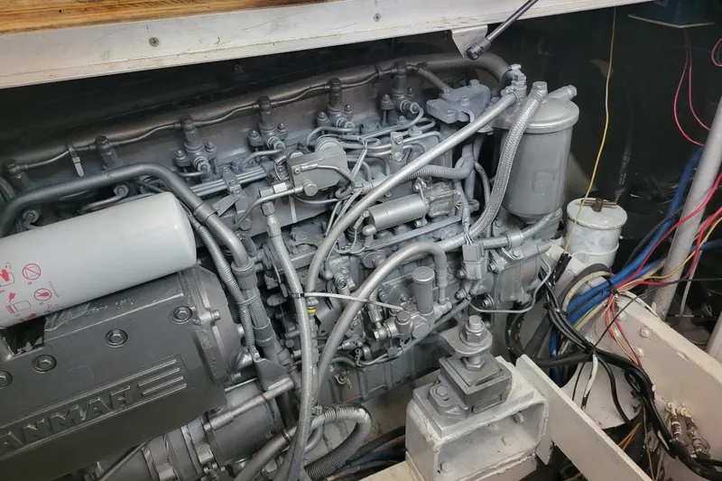 Bout Time Yacht Photos Pics Engine compartment of a 1979 Bertram 38 Convertible boat, showcasing detailed mechanical components.