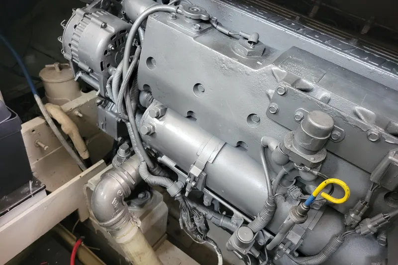 Bout Time Yacht Photos Pics Engine compartment of a 1979 Bertram 38 Convertible boat, showcasing mechanical components.