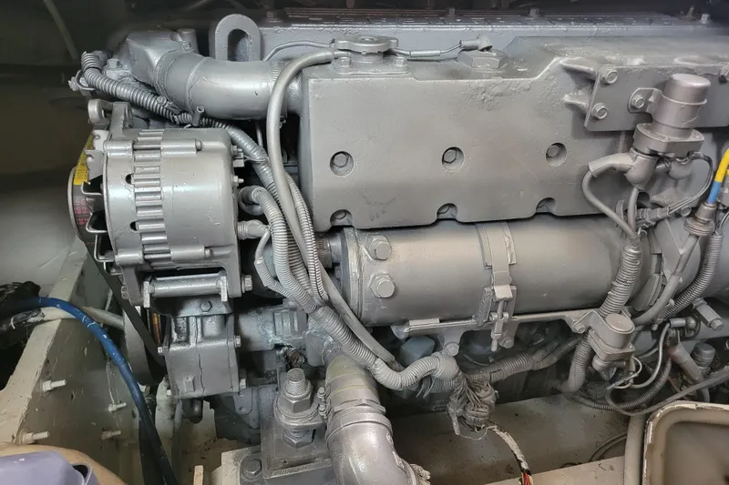 Bout Time Yacht Photos Pics Engine of a 1979 Bertram 38 Convertible boat, showcasing detailed mechanical components.