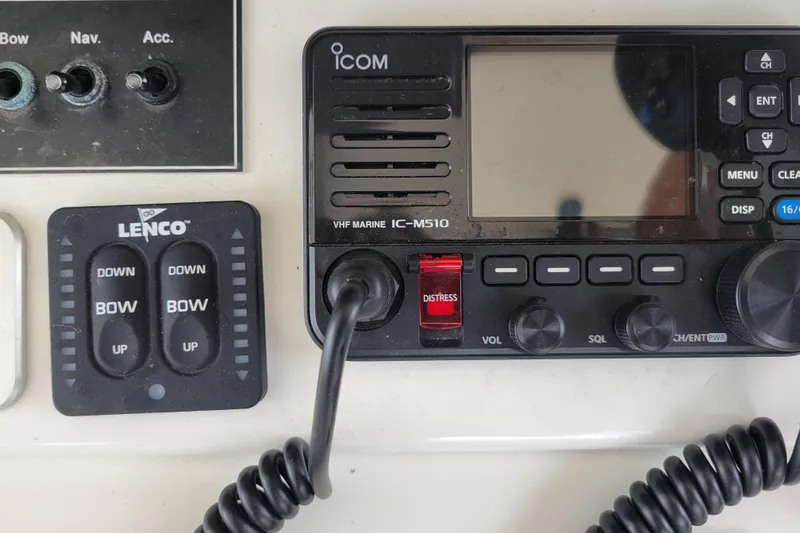Bout Time Yacht Photos Pics Control panel of a 1979 Bertram 38 Convertible with Icom VHF radio and Lenco trim tab switches.