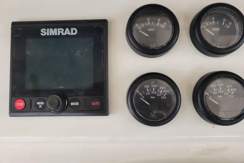 Bout Time Yacht Photos Pics Simrad display and gauges on 1979 Bertram 38 Convertible boat dashboard.