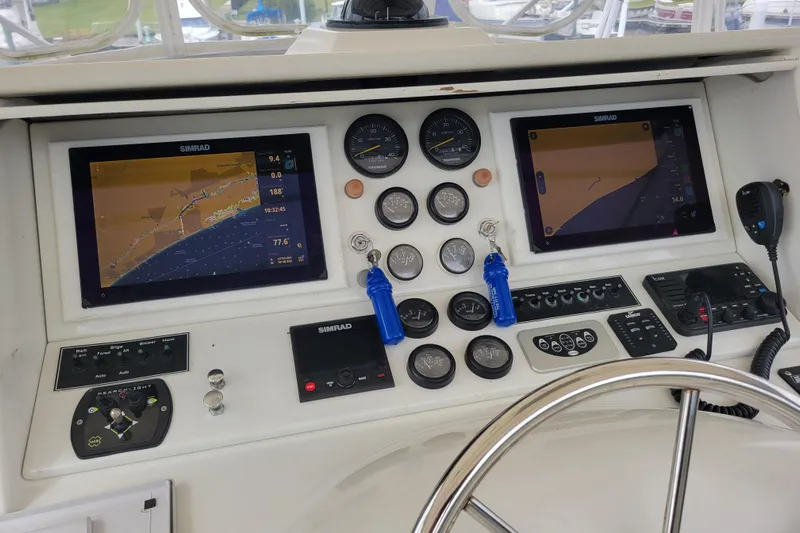 Bout Time Yacht Photos Pics 1979 Bertram 38 Convertible boat dashboard with navigation screens and controls.