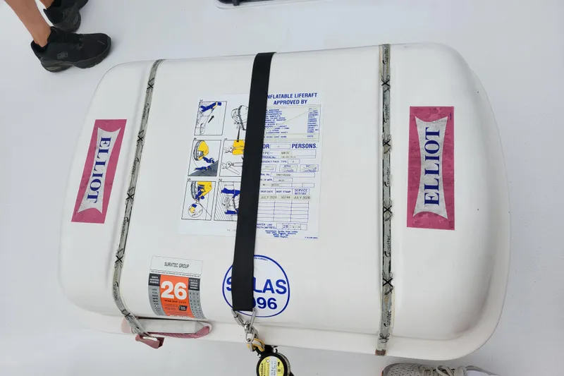 Bout Time Yacht Photos Pics Inflatable liferaft on 1979 Bertram 38 Convertible boat, labeled "Elliot" with safety instructions.