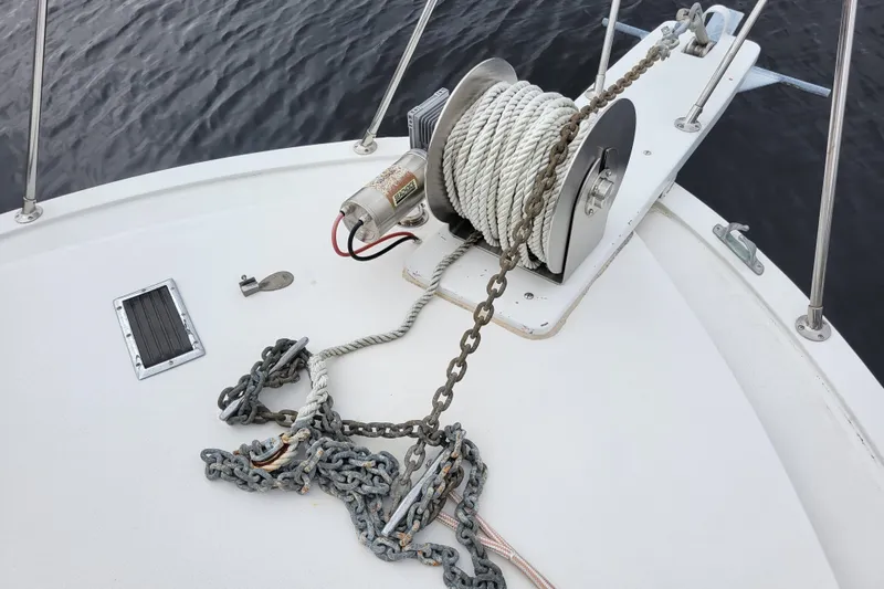 Bout Time Yacht Photos Pics Anchor winch on 1979 Bertram 38 Convertible boat deck, with rope and chain.