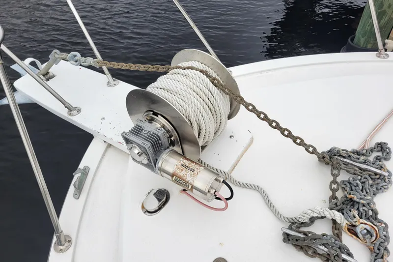 Bout Time Yacht Photos Pics Anchor winch on 1979 Bertram 38 Convertible boat deck, with rope and chain.